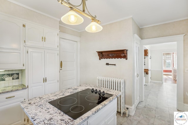 503 S 2nd St, Clinton, MO 64735 - kitchen with radiator heating unit, black electric stovetop, white cabinets, light marble finish flooring, and ornamental molding