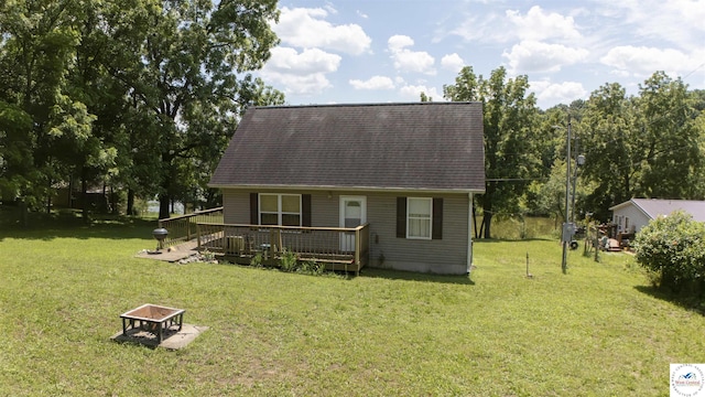 29139 Sandy Ln, Lincoln, MO 65338 - back of property featuring an outdoor fire pit, a wooden deck, a lawn, and a shingled roof