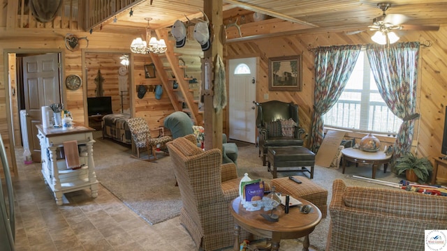 29139 Sandy Ln, Lincoln, MO 65338 - living area featuring wooden walls, a ceiling fan, a chandelier, and a wood stove