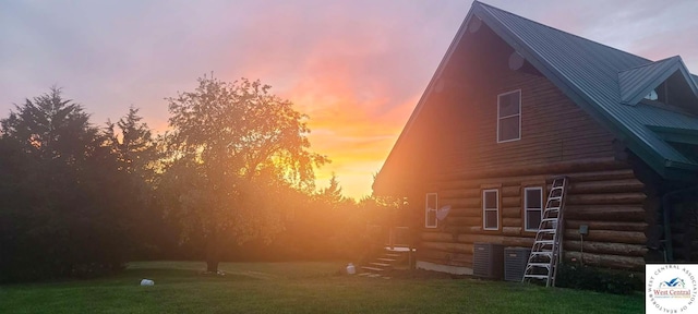 1244 SW 101st Rd, Chilhowee, MO 64733 - property exterior at dusk with a yard, log exterior, and metal roof