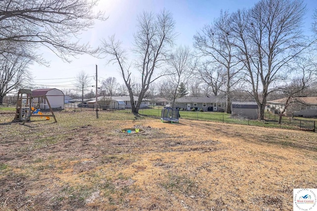 view of yard with fence and a playground