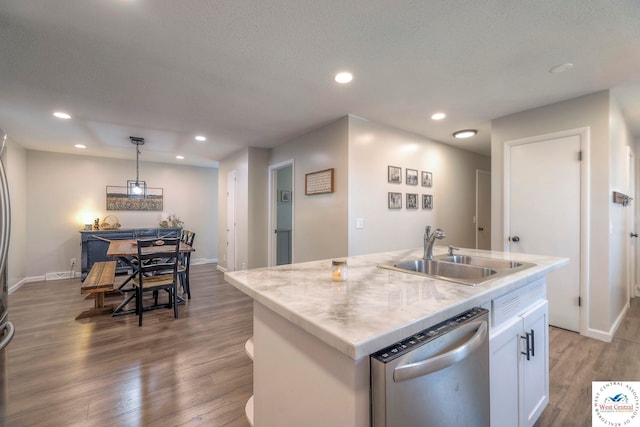 kitchen with white cabinetry, dishwasher, recessed lighting, and a sink