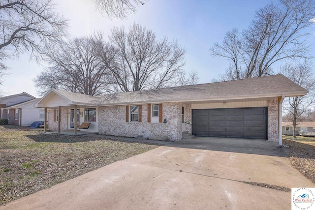 ranch-style house featuring a porch, brick siding, driveway, roof with shingles, and an attached garage
