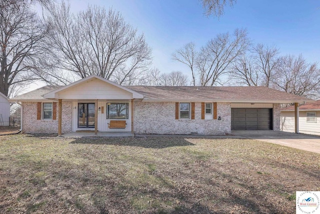 ranch-style home with driveway, a front yard, brick siding, and a garage