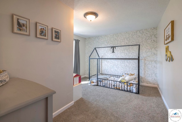carpeted bedroom featuring a textured ceiling, wallpapered walls, and baseboards