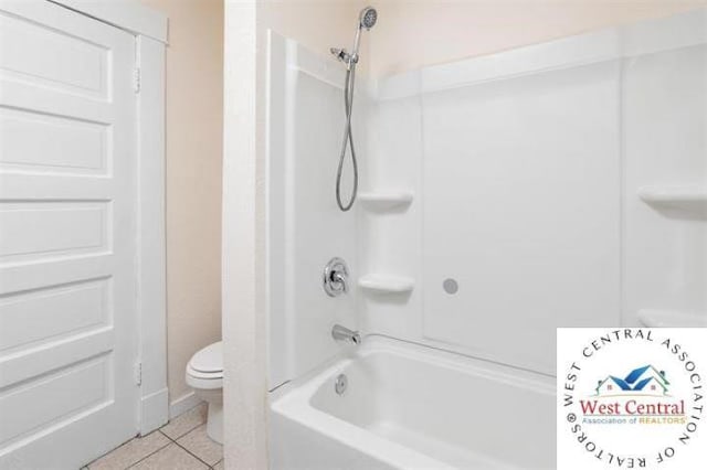 full bath featuring tile patterned floors, toilet, and tub / shower combination