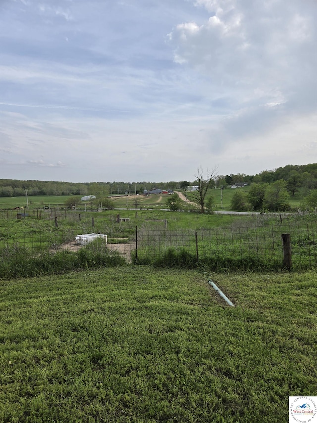 view of yard featuring fence and a rural view