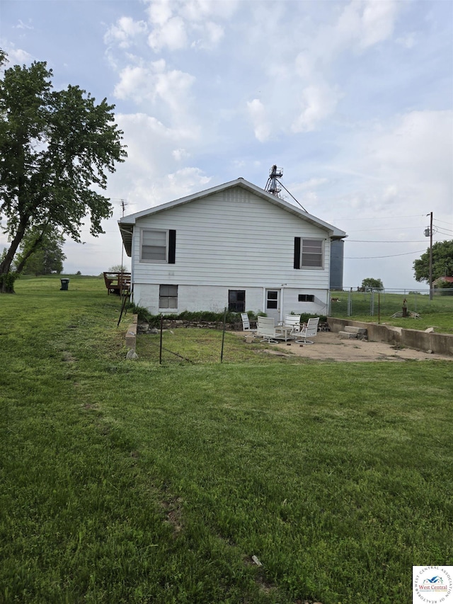 back of property featuring a lawn and a patio area