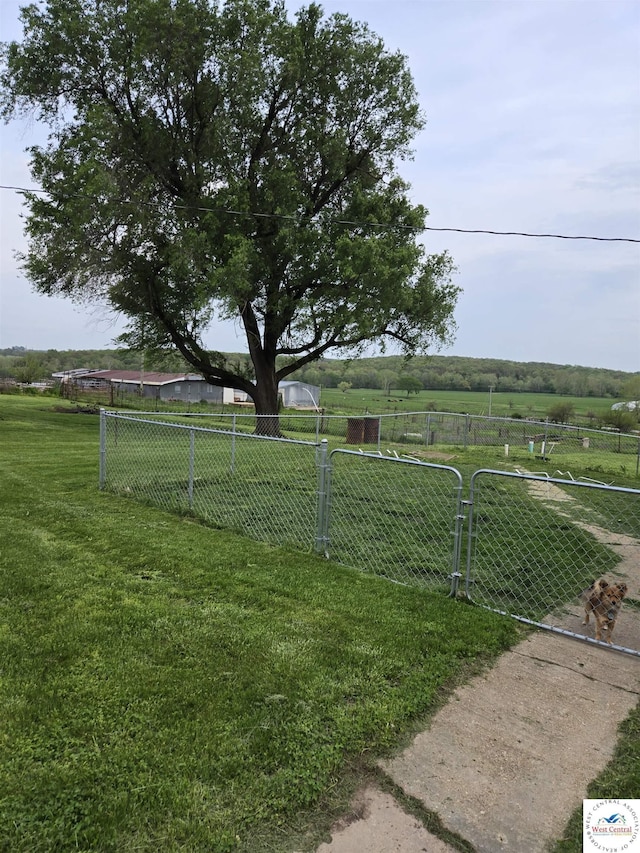 view of yard featuring a rural view and fence