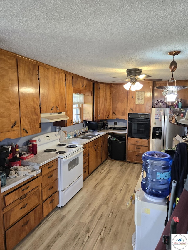 kitchen featuring black oven, white electric range, brown cabinets, dishwasher, and under cabinet range hood