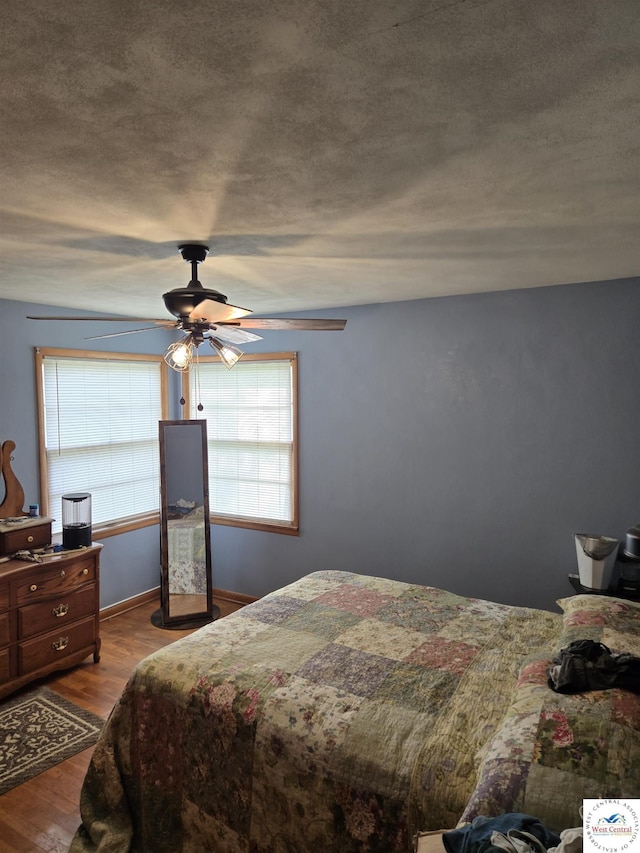 bedroom with ceiling fan and wood finished floors