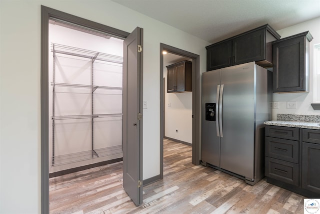 704 E 16th St, Sedalia, MO 65301 - kitchen featuring stainless steel fridge, light wood-style flooring, and baseboards