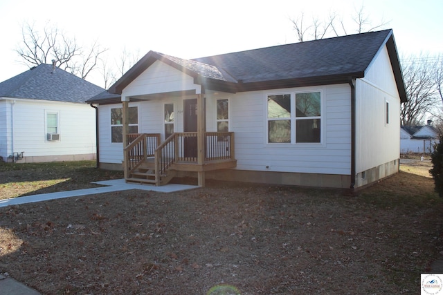 ranch-style house with cooling unit and a shingled roof