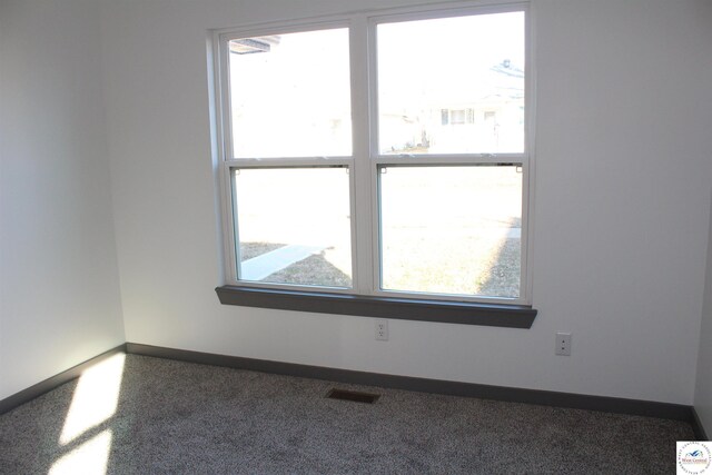 unfurnished room featuring visible vents and baseboards