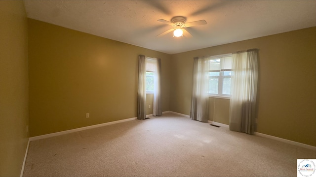 21609 Valley Rd, Warsaw, MO 65355 - unfurnished room with a ceiling fan, visible vents, light carpet, and baseboards