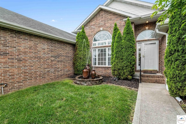 3375 Cedar St, Sedalia, MO 65301 - doorway to property with brick siding and a lawn