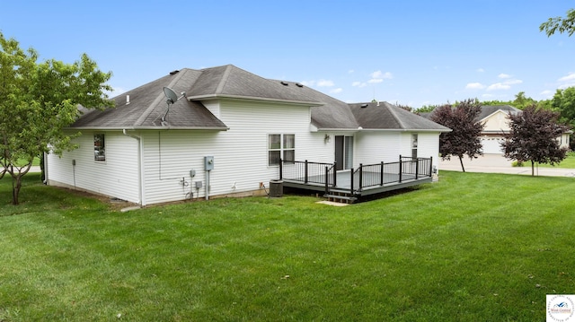 3375 Cedar St, Sedalia, MO 65301 - rear view of house with a deck, a shingled roof, and a lawn