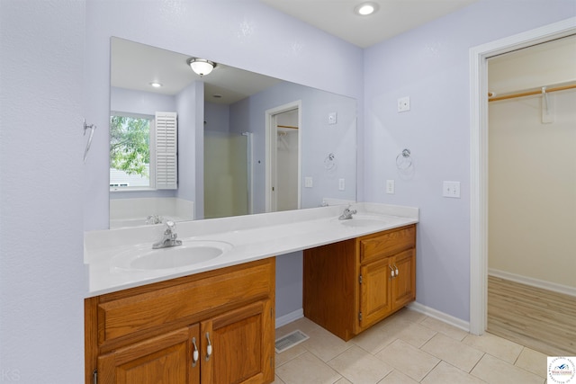3375 Cedar St, Sedalia, MO 65301 - bathroom featuring double vanity, a walk in closet, and tile patterned flooring
