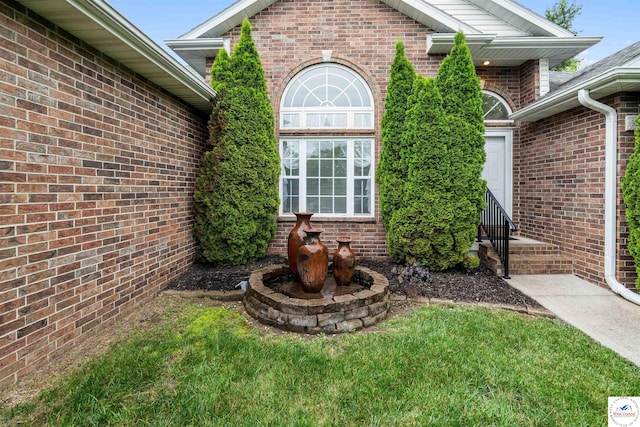 3375 Cedar St, Sedalia, MO 65301 - doorway to property with brick siding and a lawn