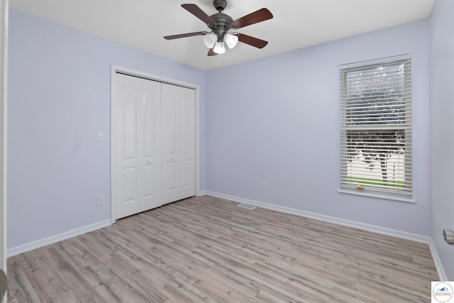 3375 Cedar St, Sedalia, MO 65301 - unfurnished bedroom featuring light wood finished floors, a closet, and a ceiling fan