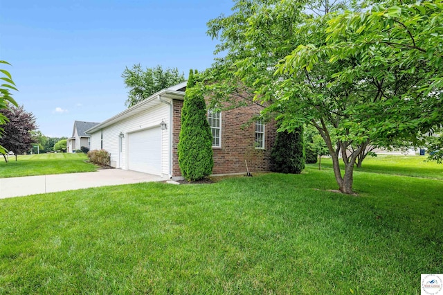 3375 Cedar St, Sedalia, MO 65301 - view of side of home with a yard, an attached garage, brick siding, and driveway