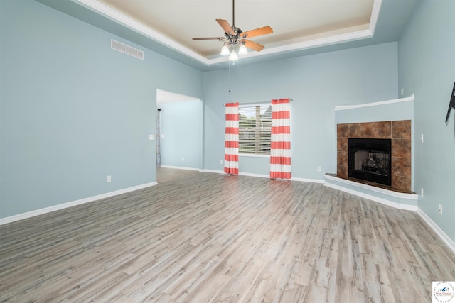 3375 Cedar St, Sedalia, MO 65301 - unfurnished living room with a raised ceiling, ceiling fan, wood finished floors, and a tile fireplace