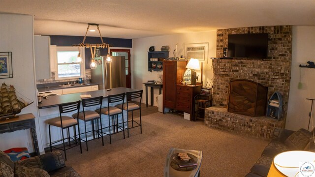 29781 Lake Road 57 Rd, Warsaw, MO 65355 - carpeted living area featuring a wall unit AC, a brick fireplace, and a textured ceiling