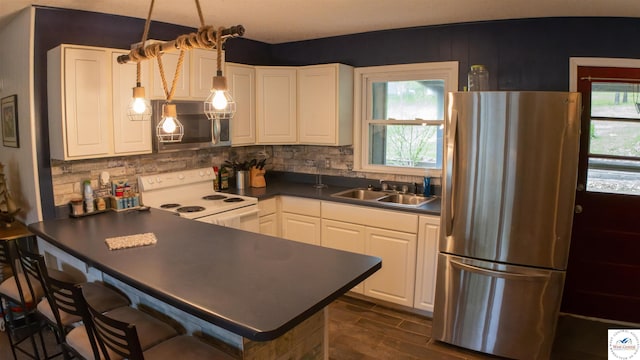 29781 Lake Road 57 Rd, Warsaw, MO 65355 - kitchen with a sink, dark countertops, stainless steel appliances, and white cabinetry