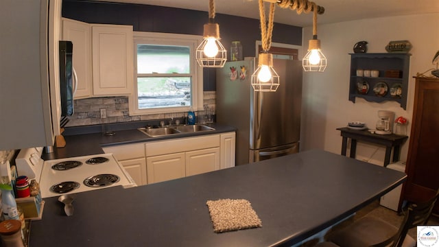 29781 Lake Road 57 Rd, Warsaw, MO 65355 - kitchen featuring dark countertops, white range with electric cooktop, a sink, white cabinets, and freestanding refrigerator