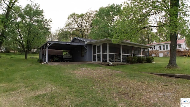 29781 Lake Road 57 Rd, Warsaw, MO 65355 - back of house featuring a yard, an attached carport, and a sunroom