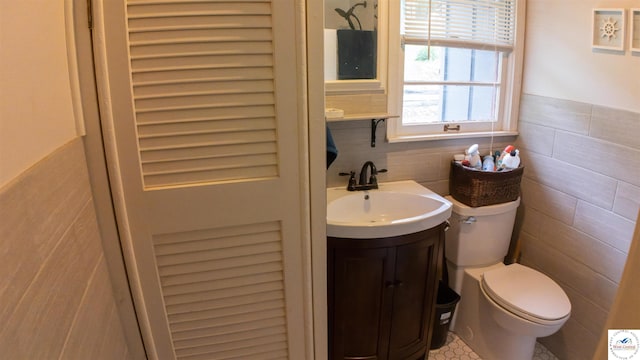 29781 Lake Road 57 Rd, Warsaw, MO 65355 - bathroom featuring vanity, wainscoting, toilet, and tile walls