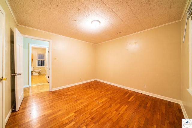 1315 Maple Ln, Sedalia, MO 65301 - unfurnished bedroom featuring baseboards, light wood-style floors, and crown molding