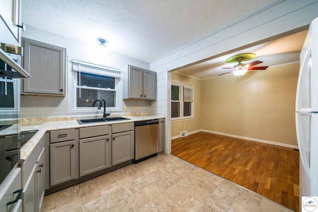 1315 Maple Ln, Sedalia, MO 65301 - kitchen featuring gray cabinetry, stainless steel dishwasher, and a sink