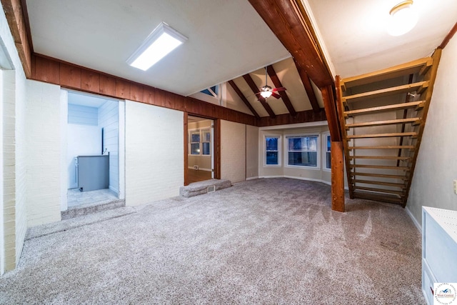 1315 Maple Ln, Sedalia, MO 65301 - unfurnished living room featuring a ceiling fan, stairs, lofted ceiling, and carpet floors