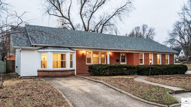 1315 Maple Ln, Sedalia, MO 65301 - ranch-style home with roof with shingles, concrete driveway, and brick siding