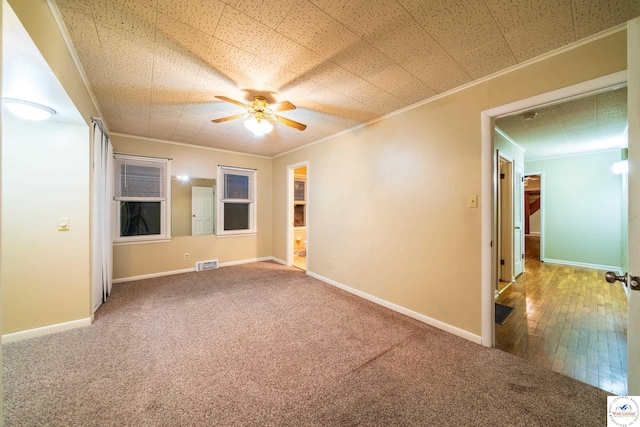 1315 Maple Ln, Sedalia, MO 65301 - carpeted spare room with visible vents, crown molding, a ceiling fan, and baseboards