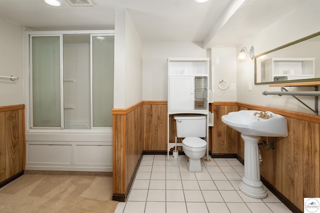 5900 Apple Rd, Sedalia, MO 65301 - bathroom with toilet, a shower with shower door, visible vents, wood walls, and wainscoting