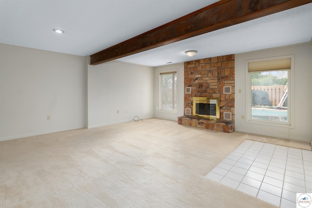 5900 Apple Rd, Sedalia, MO 65301 - unfurnished living room featuring baseboards, beamed ceiling, carpet floors, and a stone fireplace