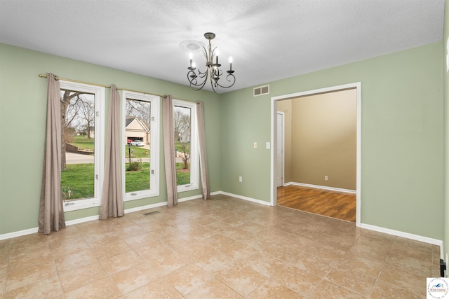 5900 Apple Rd, Sedalia, MO 65301 - empty room featuring baseboards, visible vents, light tile patterned floors, and a notable chandelier