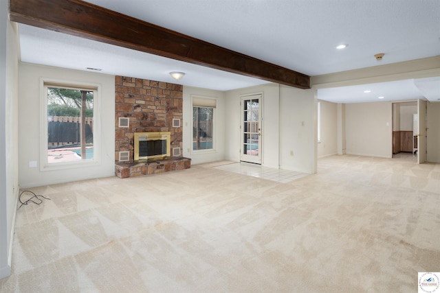 5900 Apple Rd, Sedalia, MO 65301 - unfurnished living room featuring recessed lighting, beam ceiling, a stone fireplace, carpet, and baseboards