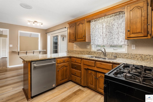 5900 Apple Rd, Sedalia, MO 65301 - kitchen featuring a sink, black range with gas cooktop, dishwasher, and brown cabinetry
