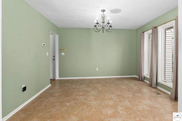 5900 Apple Rd, Sedalia, MO 65301 - empty room with visible vents, a notable chandelier, baseboards, and plenty of natural light