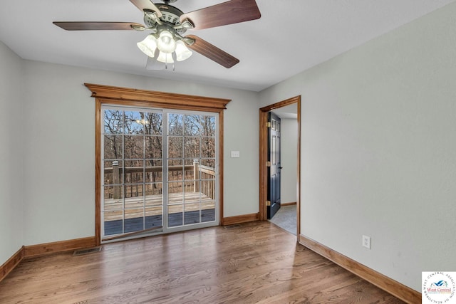 21439 Lost Rd, Warsaw, MO 65355 - spare room with baseboards, visible vents, wood finished floors, and ceiling fan