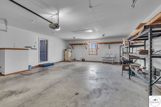 21439 Lost Rd, Warsaw, MO 65355 - garage with a garage door opener, water heater, and baseboards