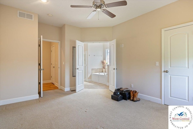 22714 Lake Dr, Warsaw, MO 65355 - unfurnished bedroom featuring light colored carpet, ensuite bath, and ceiling fan