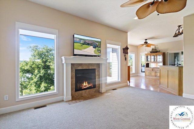 22714 Lake Dr, Warsaw, MO 65355 - unfurnished living room featuring a ceiling fan, carpet floors, and a tiled fireplace