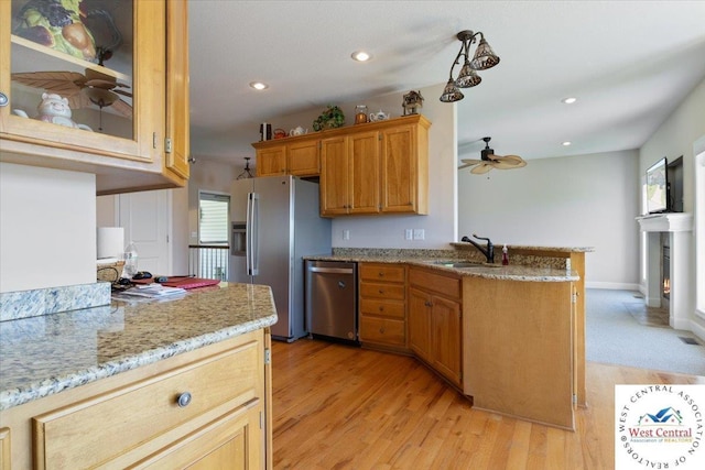 22714 Lake Dr, Warsaw, MO 65355 - kitchen featuring stainless steel appliances, ceiling fan, light wood finished floors, a peninsula, and recessed lighting