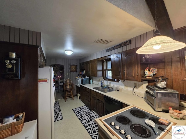 512 N Price Ln, Clinton, MO 64735 - kitchen featuring a sink, dark brown cabinetry, light countertops, dishwasher, and freestanding refrigerator