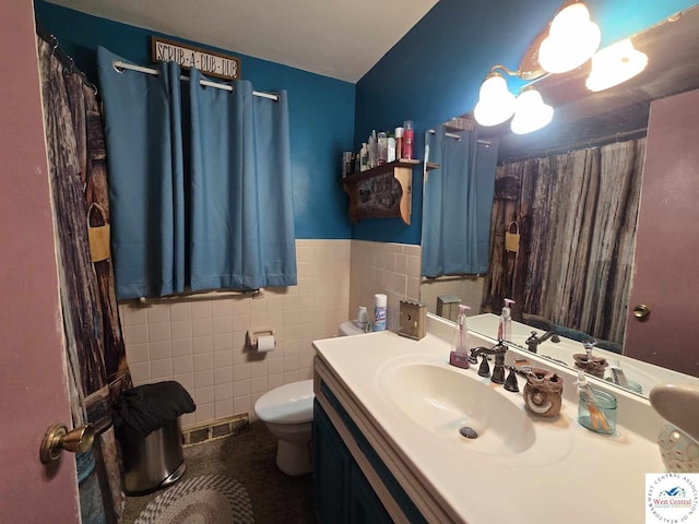 512 N Price Ln, Clinton, MO 64735 - bathroom with visible vents, a wainscoted wall, toilet, tile walls, and vanity