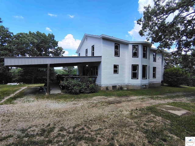 1105 Lay Ave, Warsaw, MO 65355 - view of property exterior with an attached carport and driveway